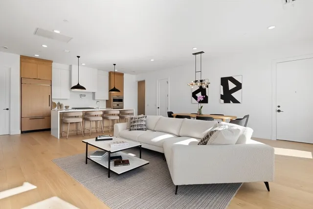 a living room with furniture gym equipment and a chandelier