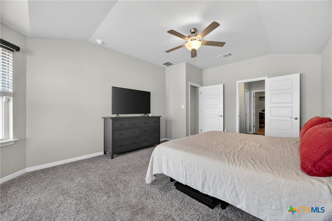 1036 View Drive Georgetown, TX 78628 - Photo 15 of 33 a bedroom with a bed and a flat screen tv