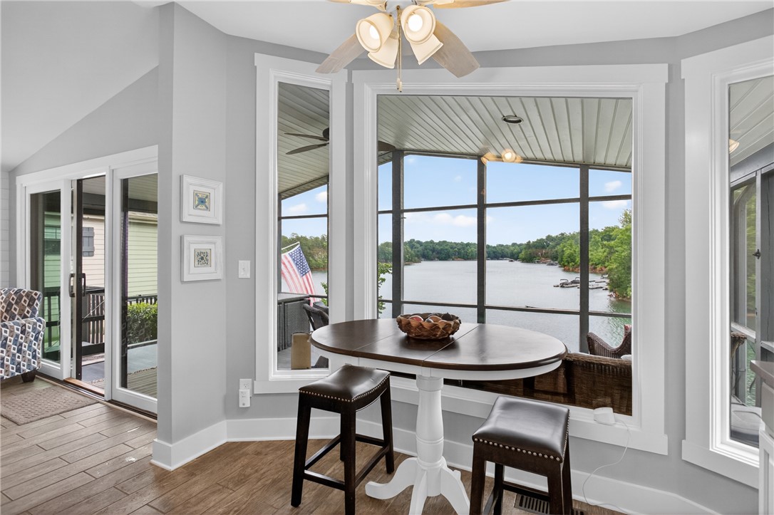 1230 Melton Road, Unit 4 West Union, SC 29696 - Photo 32 of 48 A breakfast nook offers panoramic views of the lake through expansive windows, perfect for morning meals.