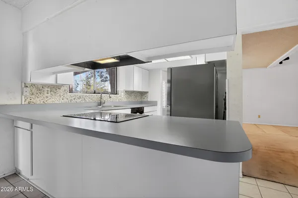 a kitchen with stainless steel appliances a sink stove and refrigerator