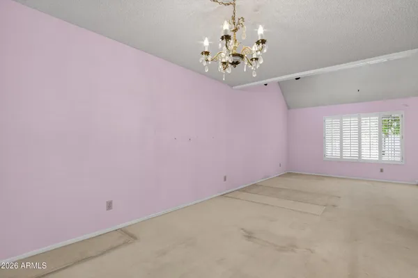 a view of an empty room with a chandelier