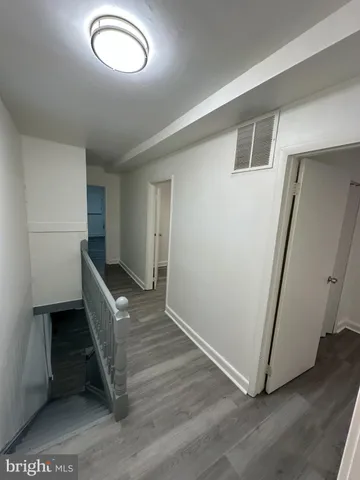 an entryway in a hall with wooden floor