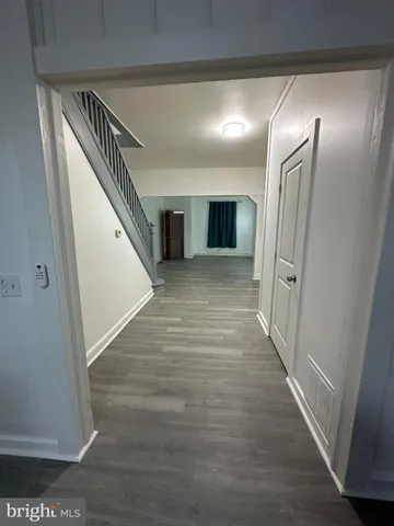 a view of hallway with wooden floor