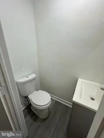 a white toilet sitting next to a shower