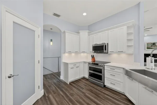 a spacious bedroom with a large bed and a window