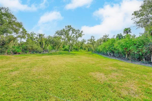 a view of a dining room with furniture wooden floor and chandelier