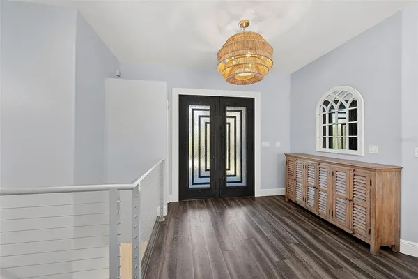a view of a dining room with furniture wooden floor and chandelier