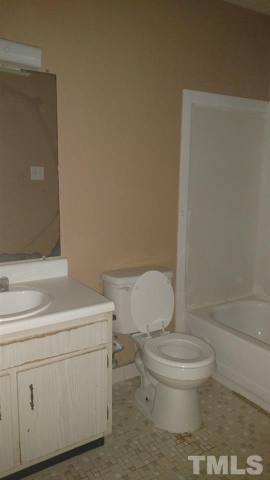 4272 Lake Ridge Drive Raleigh, NC 27604 - Photo 12 of 13 a white toilet sitting next to a bathroom sink and vanity