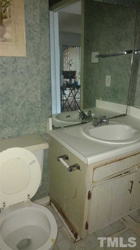 4272 Lake Ridge Drive Raleigh, NC 27604 - Photo 13 of 13 a bathroom with a sink a toilet and shower