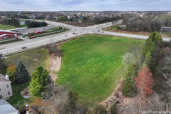 an aerial view of a house with a garden and lake view