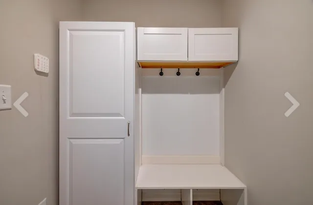 a view of a house with backyard and wooden fence