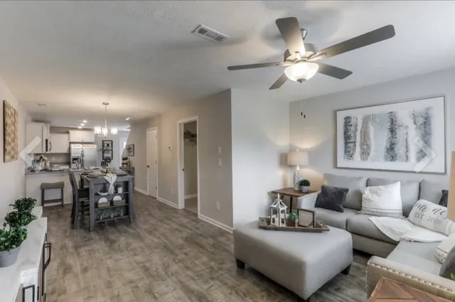 a living room with furniture and a chandelier