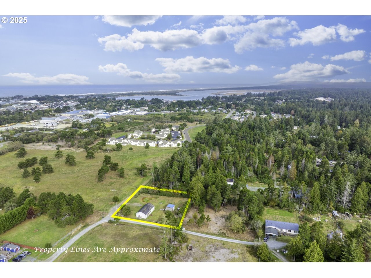 87905 Astor Lane Bandon, OR 97411 - Photo 11 of 26 an aerial view of residential houses with outdoor space and ocean view