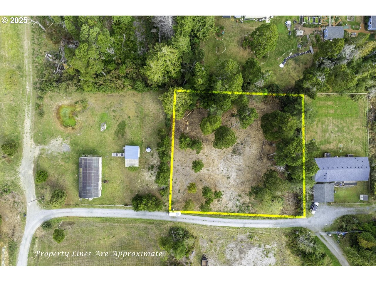 87905 Astor Lane Bandon, OR 97411 - Photo 19 of 26 an aerial view of a residential houses with outdoor space and trees