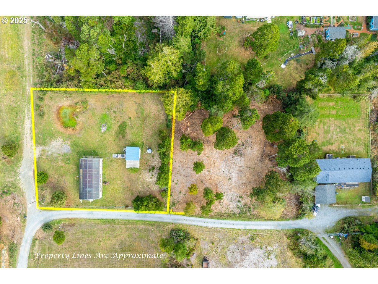 87905 Astor Lane Bandon, OR 97411 - Photo 2 of 26 an aerial view of residential houses with outdoor space and trees