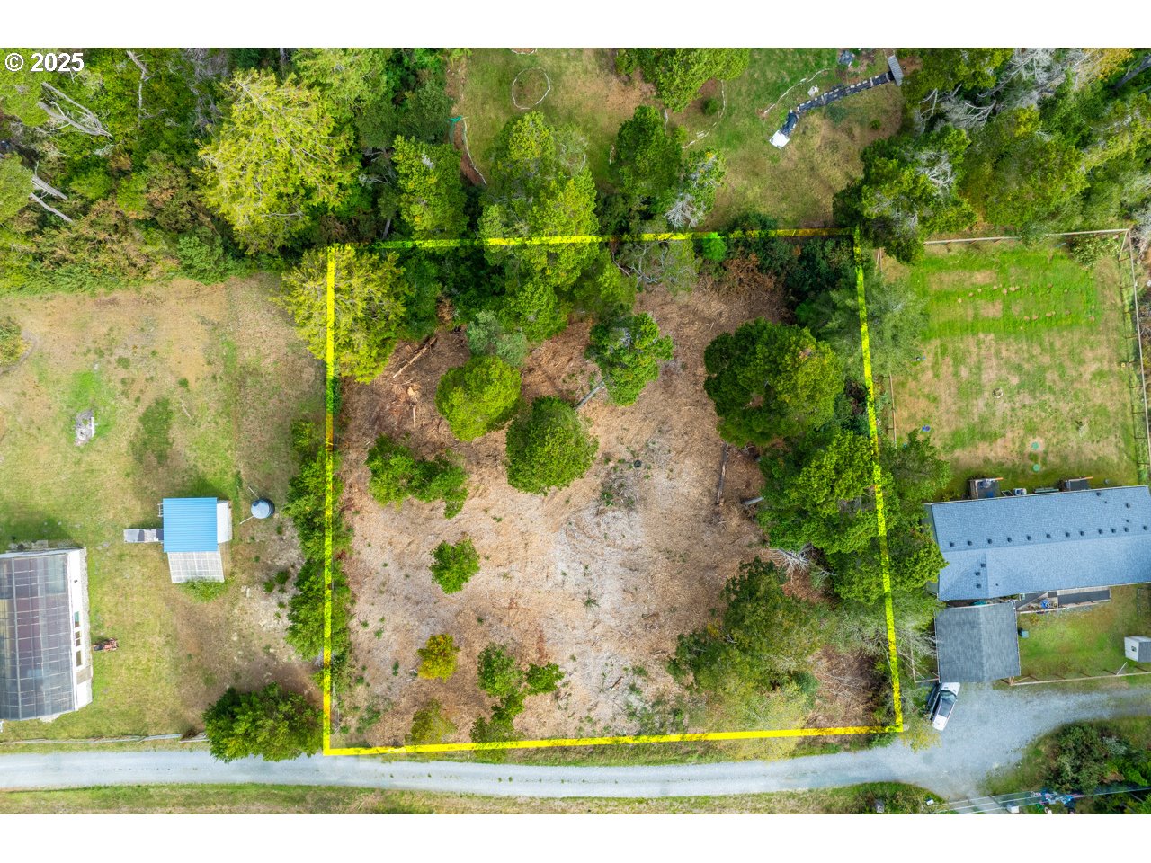 87905 Astor Lane Bandon, OR 97411 - Photo 21 of 26 an aerial view of residential houses with outdoor space and trees