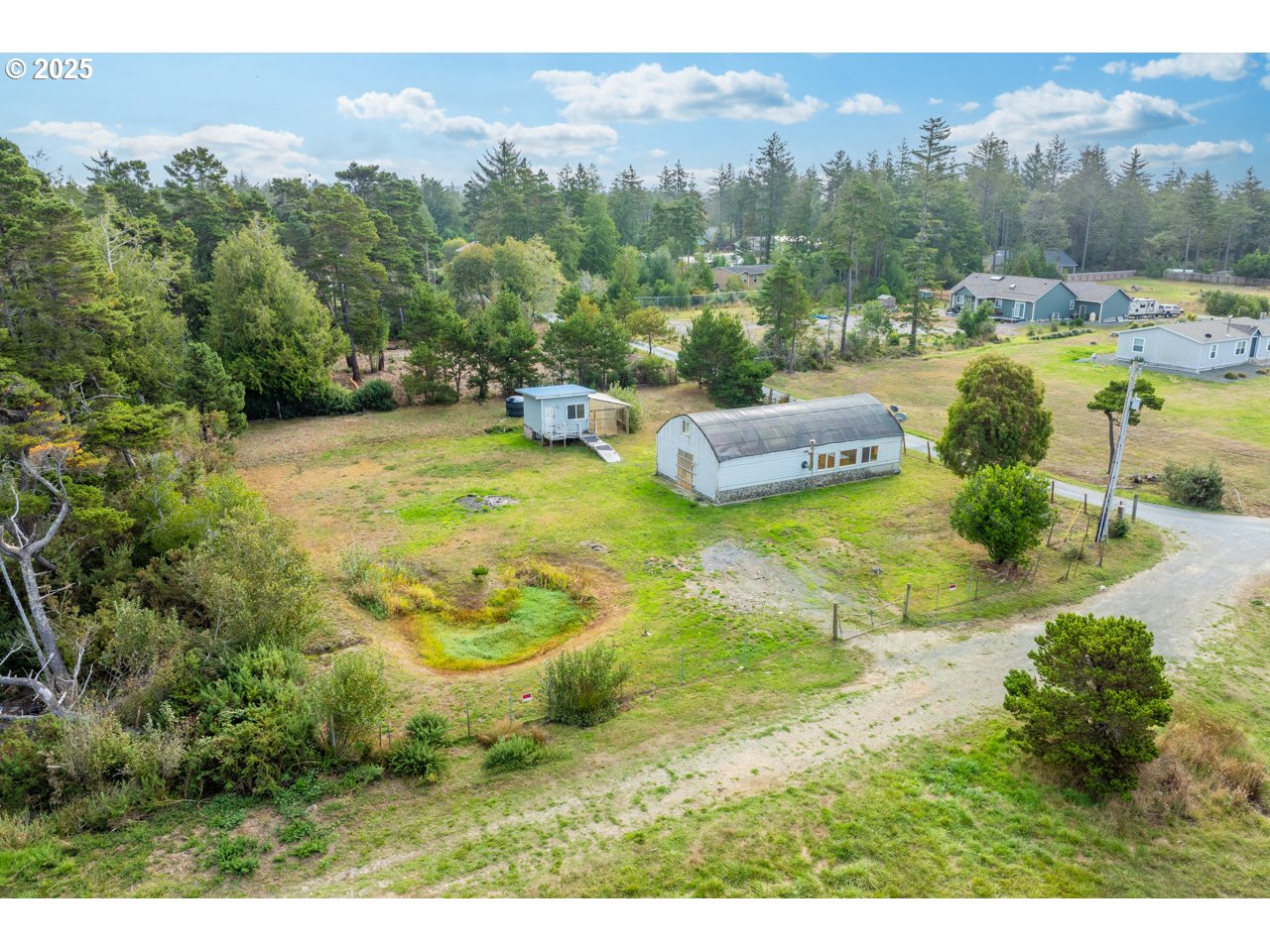 87905 Astor Lane Bandon, OR 97411 - Photo 7 of 26 a view of a swimming pool with a yard