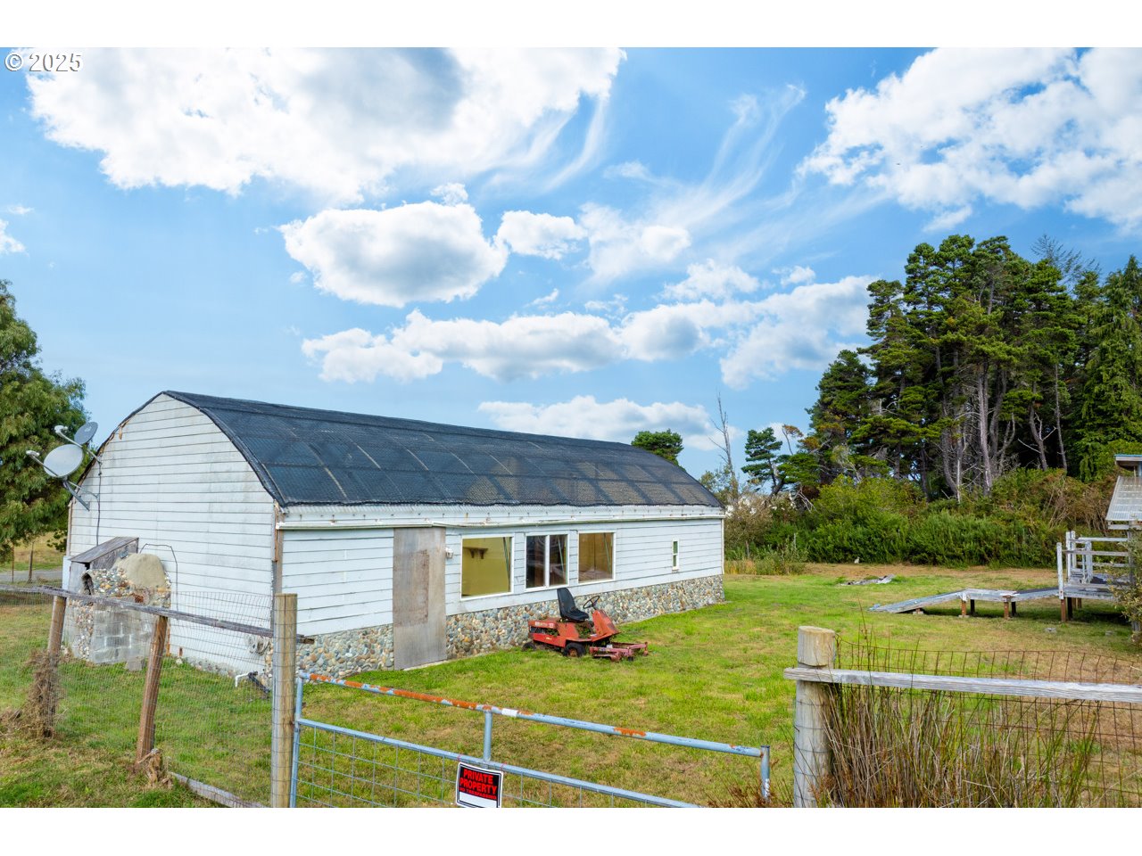 87905 Astor Lane Bandon, OR 97411 - Photo 10 of 26 a view of a house with backyard