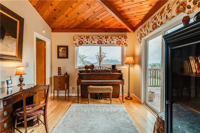 a living room with furniture a piano and a fireplace