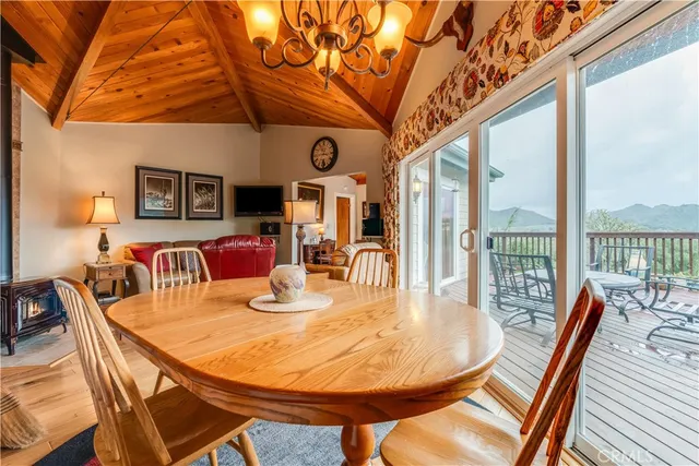a dining room with furniture a chandelier and wooden floor