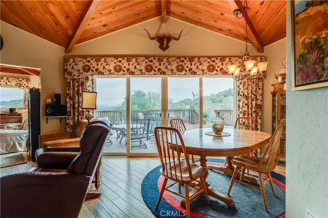 a dining room with furniture a chandelier and wooden floor