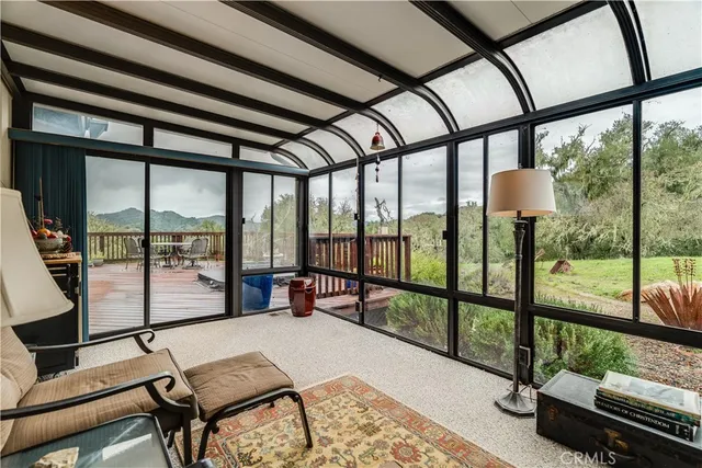 a bedroom with furniture and large window