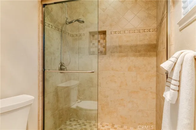 a bedroom with a bed bookshelf and a large window