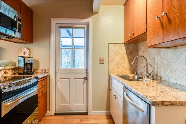 a kitchen with a sink stove and cabinets
