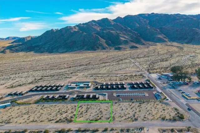a view of a lake with beach and city view