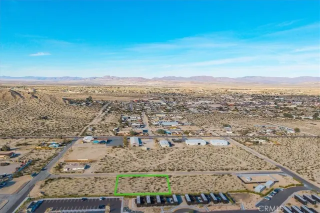 an aerial view of residential building and ocean view in back