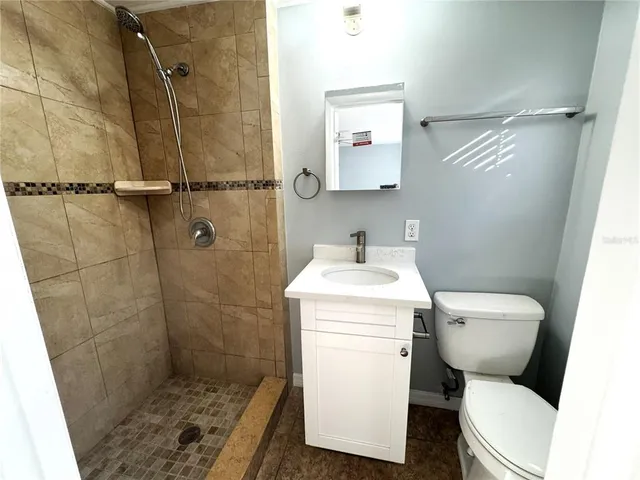 a bathroom with a toilet sink and shower