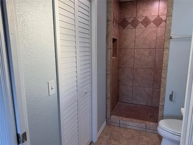 a bathroom with a shower and a toilet
