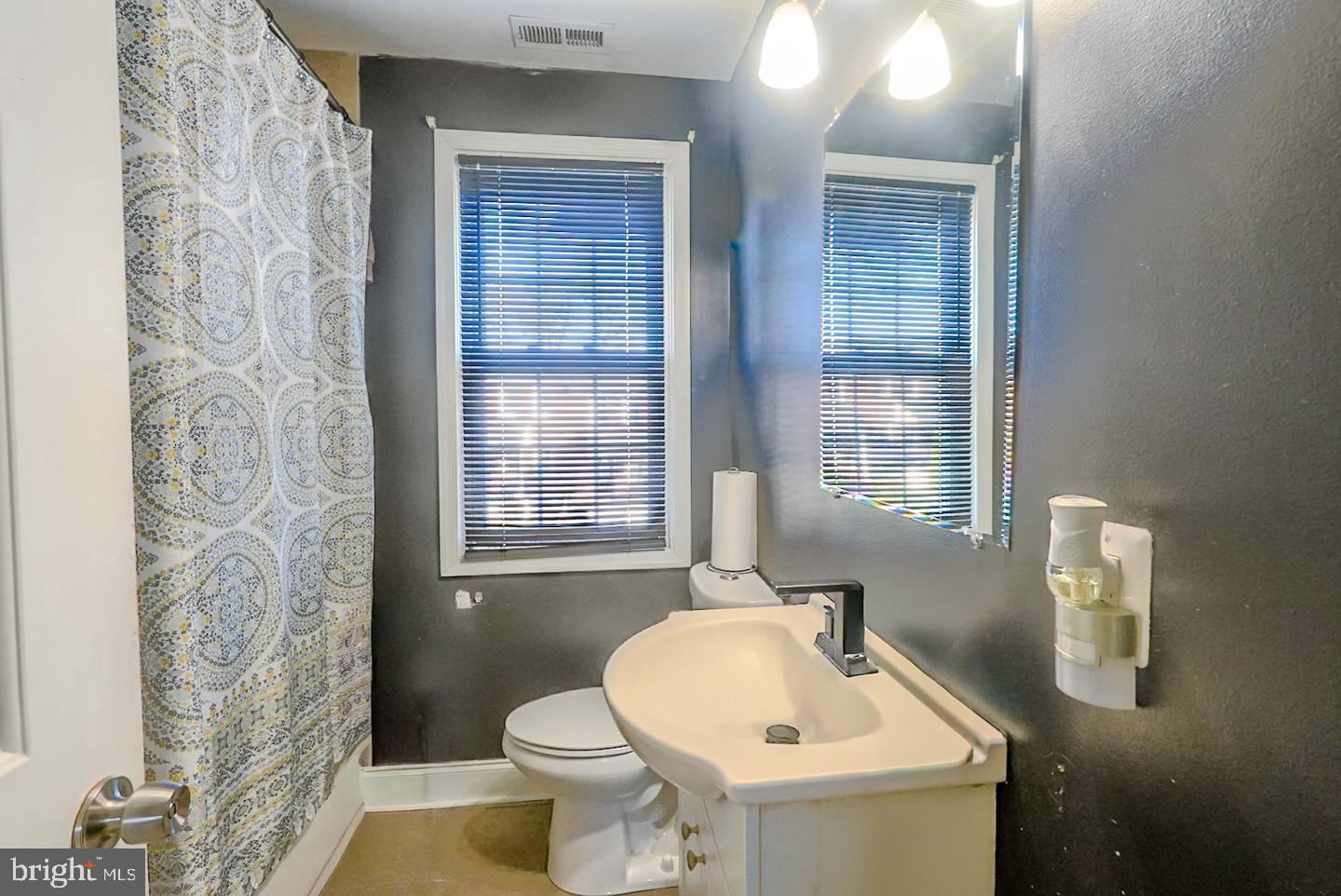3915 Flowerton Road Baltimore, MD 21229 - Photo 11 of 15 a bathroom with a sink a toilet and tub