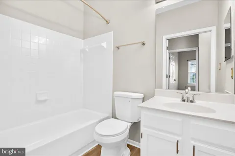 a view of a house with a yard and pathway