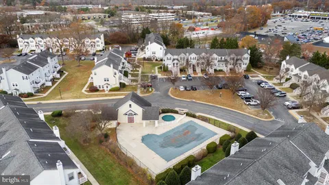 an aerial view of residential building with parking