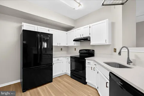 a kitchen with a sink and a refrigerator