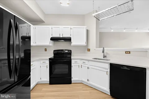 a kitchen with a refrigerator and a sink