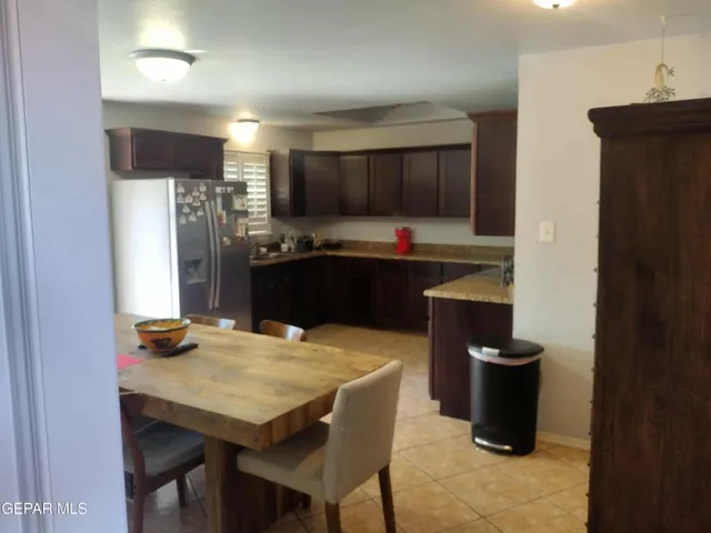 a kitchen with a table and chairs in it