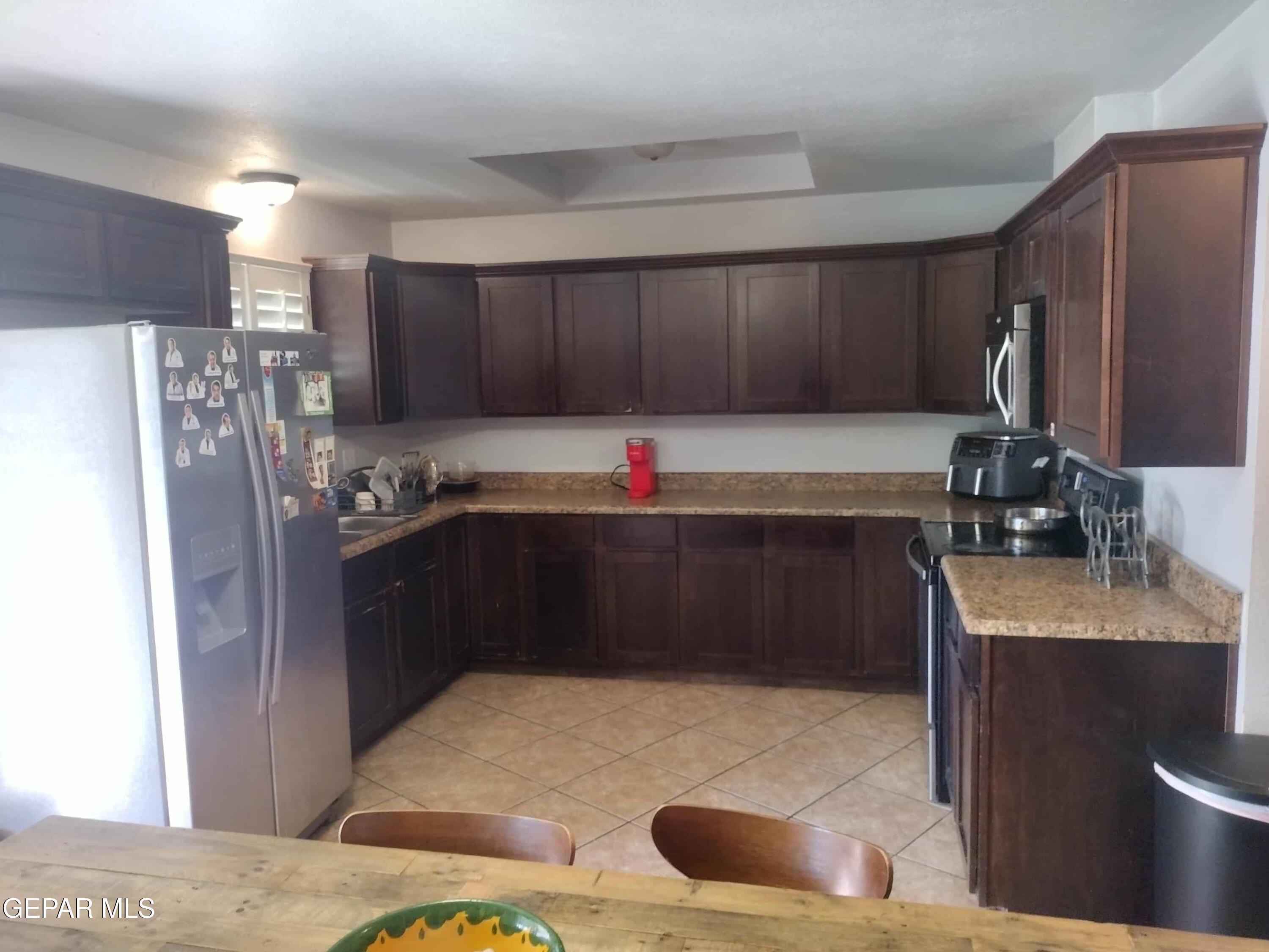 3307 Donegal Road El Paso, TX 79925 - Photo 8 of 21 a kitchen with granite countertop a refrigerator and a sink