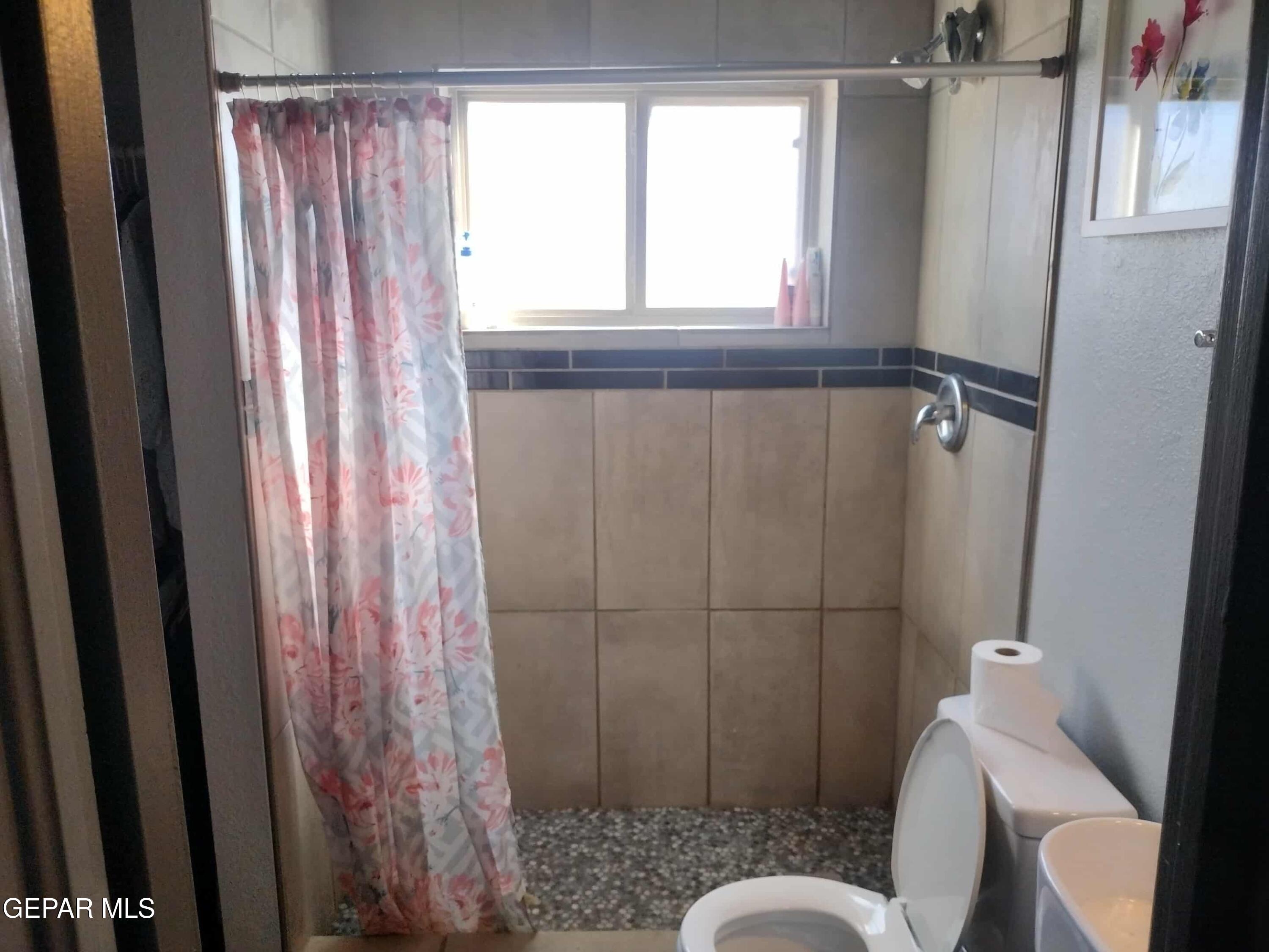 3307 Donegal Road El Paso, TX 79925 - Photo 10 of 21 a bathroom with a toilet and a shower curtain