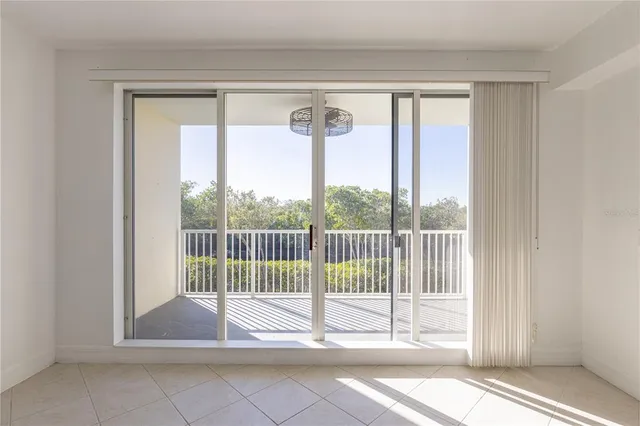 a view of a room that has a bed and a window