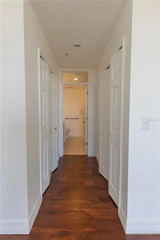a view of a hallway with wooden floor