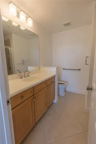 a bathroom with a sink a toilet and mirror
