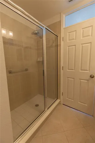 a bathroom with a glass shower door