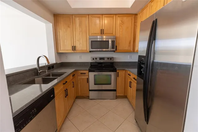 a kitchen with a sink stove and refrigerator