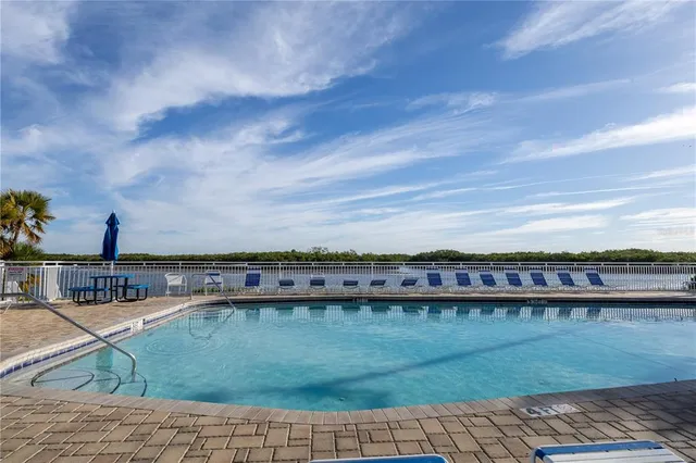 a view of a swimming pool with a yard