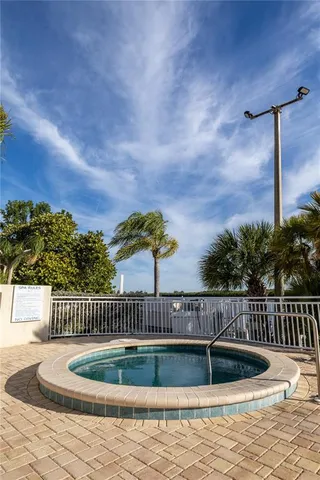 a view of a swimming pool with a patio and a lake view