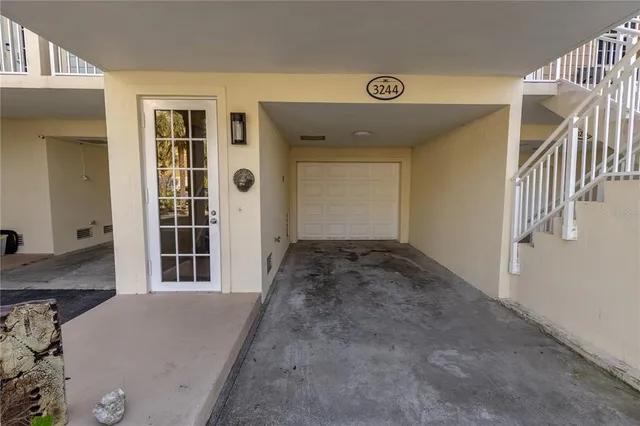 a view of a hallway with wooden floor and entryway