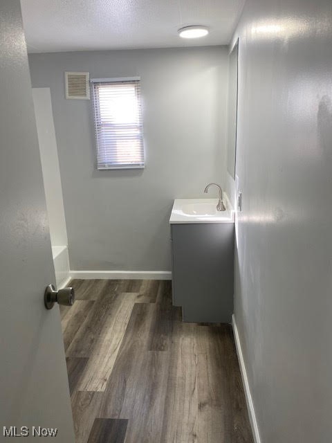3941 State Road, Unit 48 Cuyahoga Falls, OH 44223 - Photo 6 of 8 Bathroom featuring baseboards, wood finished floors, visible vents, and vanity