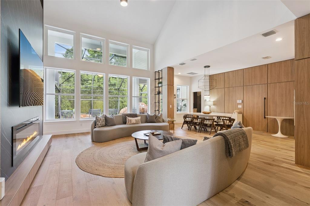 908 Croton Road Celebration, FL 34747 - Photo 20 of 86 a living room with furniture large windows and a flat screen tv